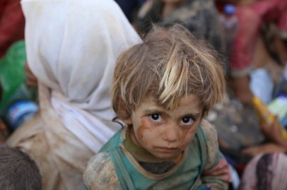 A Yezidi child who was trapped in the Sinjar mountains for days without food or water due to ISIS, arrived in the Syrian city of Haseki Aug. 10, 2014. Photo by Feriq Ferec, Anodulu Agency/Getty Images